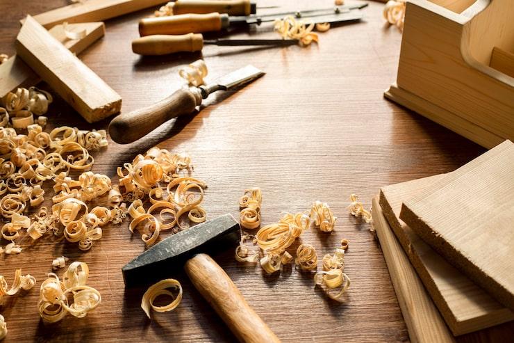 Skilled artisan craftsperson working with wood in workshop, showing passion for handmade wooden crafts